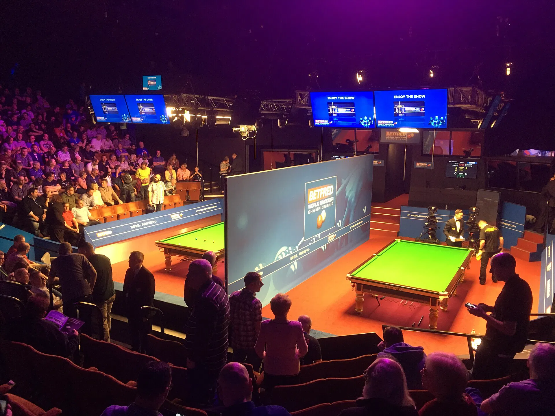 Two championship tables under broadcast lighting (Wikimedia Commons)
